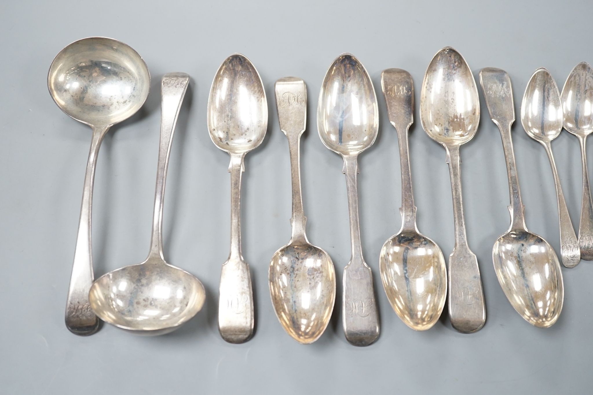 A set of six Victorian silver fiddle pattern dessert spoons, William Eaton, London, 1843, a set of six earlier silver teaspoons and a pair of George III silver sauce ladles, 14oz.